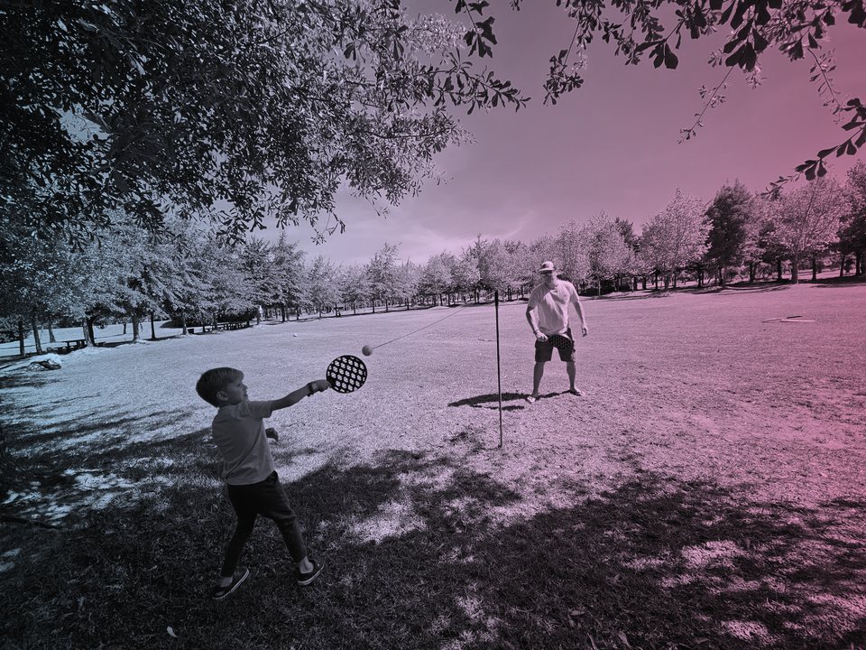 Father and son playing a game together in the park